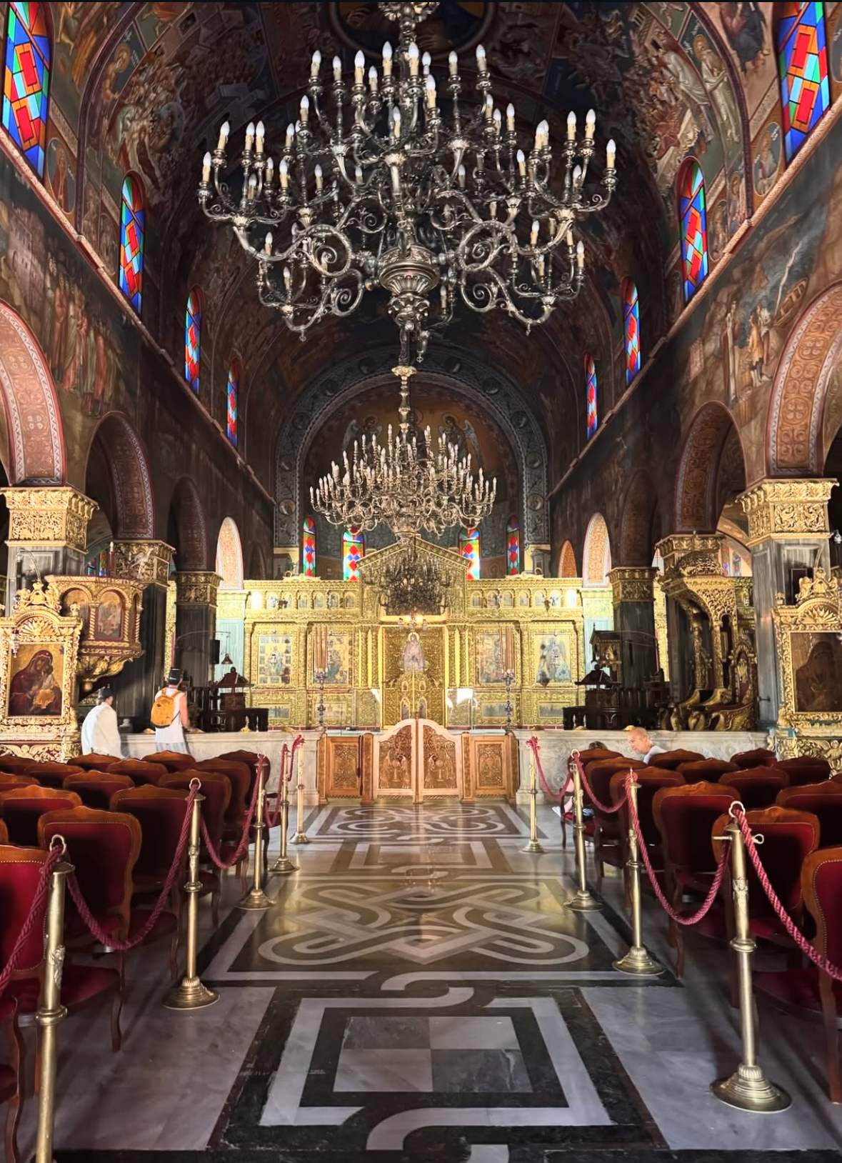 Interior of a golden orthodox church with chandeliers